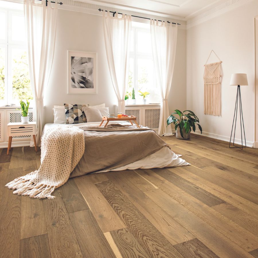 hardwood flooring in bedroom, white walls, bed